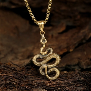 Vintage stainless steel snake pendant necklace with antique gold finish on box chain