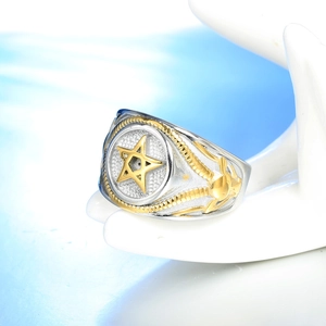 Detailed relief of skull carving on the side of a vintage two-tone star signet ring