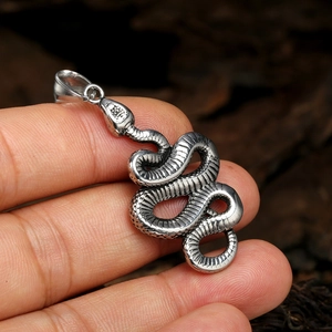 Vintage stainless steel snake pendant with detailed scales on a long necklace chain