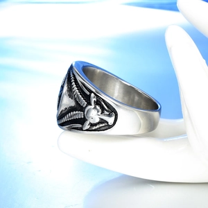 Detailed close-up of a vintage silver goat head Baphomet engraving on a gothic ring