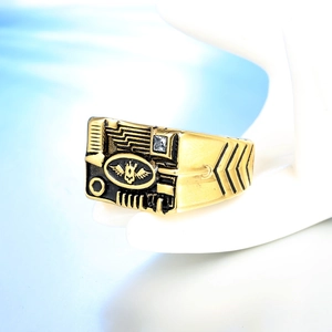Mechanical style signet ring with gold-tone wings emblem and clear zircon side stone