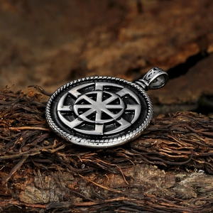 Macro detail of vintage Viking Kolovrat pendant on natural tree bark background