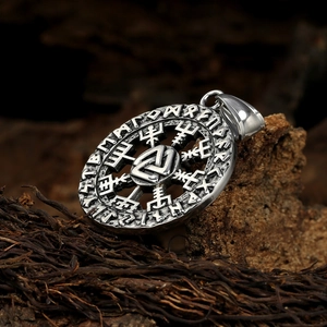 Vintage Viking Valknut necklace pendant with Nordic runes on a rustic wood background