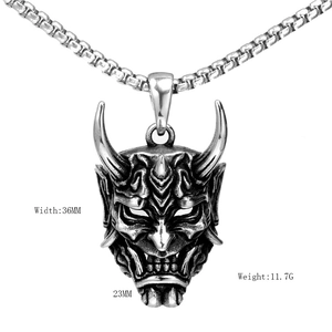 Macro detail of retro Oni mask pendant showing 36mm width and stainless steel texture