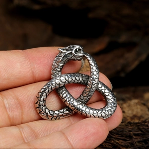 Handheld vintage silver double snake pendant with Celtic knot and dragon scale texture