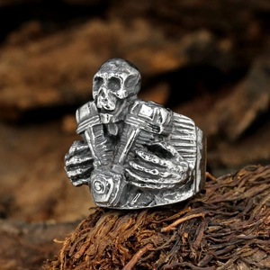 Vintage gothic skull ring with V-twin motorcycle engine detail in oxidized steel