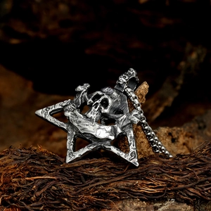 Macro shot of punk style stainless steel skull pendant with pentagram and box chain