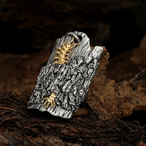 Rugged stainless steel necklace pendant with gold centipede on wood texture tag