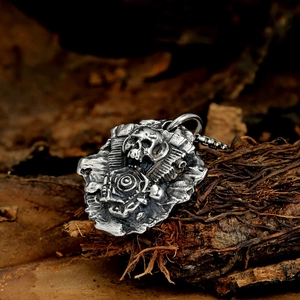 Macro shot of punk style steel skull pendant with engine details on a dark wood background