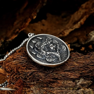Macro shot of vintage silver lion pendant with embossed details and box chain