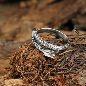 Detailed view of vintage silver steel ring featuring wood grain texture and arrow tip