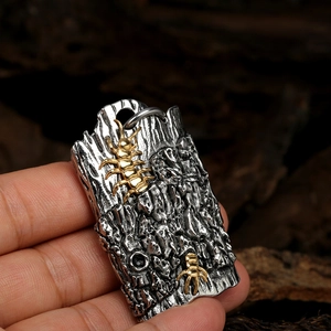 Macro shot of hip hop centipede pendant with gold insects and textured steel base