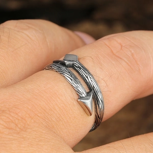 Macro detail of retro arrow-shaped open ring in vintage silver titanium steel