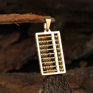 Polished gold abacus pendant in stainless steel displayed on a natural wooden root