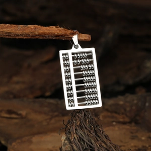 Polished silver stainless steel abacus pendant necklace hanging on natural rustic wood branch