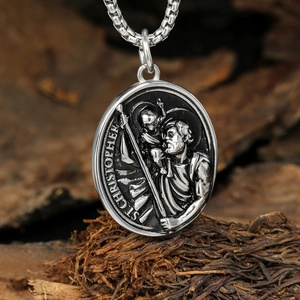Vintage St. Christopher stainless steel pendant on a chain atop rustic wood