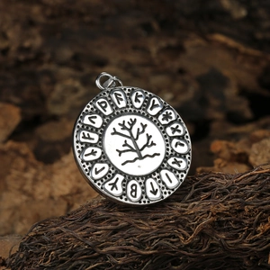 Vintage stainless steel Tree of Life pendant with Viking Runes on dark wood background