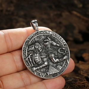 Vintage stainless steel Anubis coin pendant with ancient Egyptian motifs held by hand