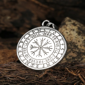 Vintage stainless steel Viking Vegvisir tree of life pendant with Runes on wood background