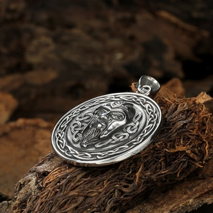 Nordic Viking warrior pendant in vintage stainless steel on a rustic wooden background