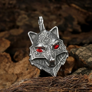 Vintage Viking tree of life wolf head pendant with red gems on rustic wood background