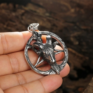 Retro stainless steel pentagram pendant with a detailed monster head on a rustic background