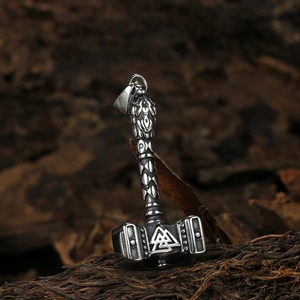 Viking Thor's Hammer Mjölnir necklace with Valknut symbol on rustic wood background