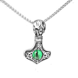 Detailed close-up of a Viking Mjolnir pendant with a skull top and green dragon eye stone