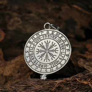 Vintage Viking compass stainless steel pendant necklace on rustic wood background