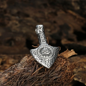 Vintage stainless steel Viking Mjolnir pendant with Valknut symbol on natural wood background