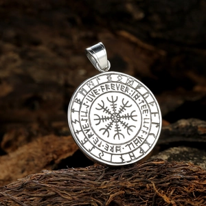 Vintage stainless steel Viking compass pendant with runic carvings on rustic wood background