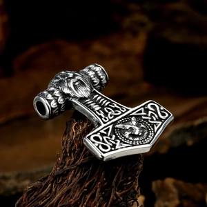 Nordic Viking Mjölnir pendant with lion head and Celtic knots on rustic wood