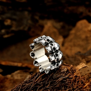 Vintage gothic skull ring for men with oxidized punk style silver finish on wood