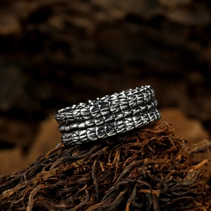 Macro shot of retro stainless steel ring with dragon scale texture and antique finish
