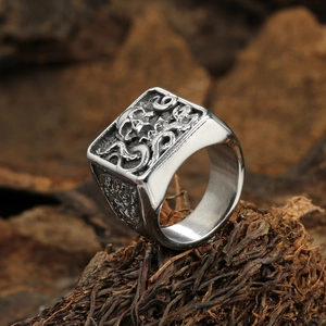 Macro detail of gothic signet ring featuring octopus and skull relief in retro steel