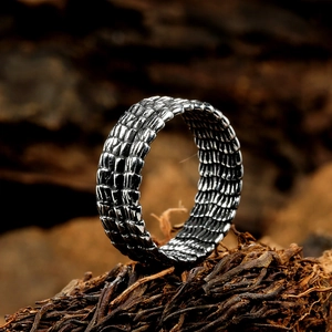 Vintage stainless steel dragon scale ring for men with retro textured finish on wood