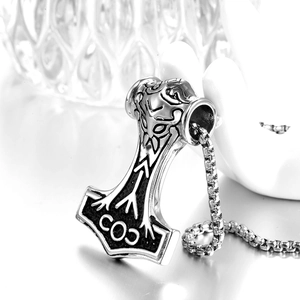 Macro shot of Mjölnir pendant with Nordic runes and COJ engraving on stainless steel necklace