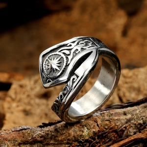 Vintage stainless steel sun god shield ring for men with Nordic totems on wood background