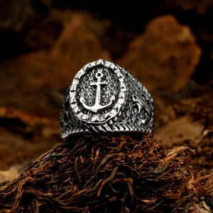 Macro shot of vintage silver anchor ring with embossed texture and antique finish