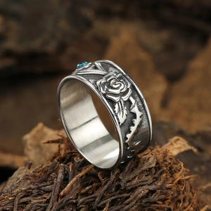 Detail of gothic rose relief ring with thorn vine textures and blue gemstone inlay