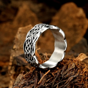 Vintage silver Celtic knot stainless steel ring displayed on rustic wood background