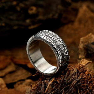 Vintage Nordic Viking rune engraved punk titanium steel ring for men on natural wood moss