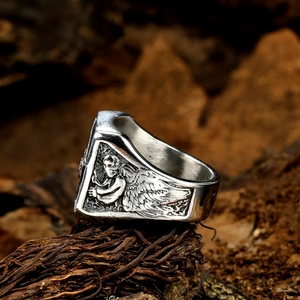 Detailed relief of an angel statue on the side of a vintage gothic silver skull ring