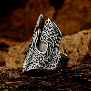 Close-up of Spartan helmet warrior mask ring with vintage Nordic engraving on bark