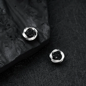 Silver magnetic stud earrings with twisted metal design and black crystal center