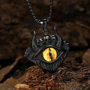 Vue macro du pendentif œil de démon gothique avec crânes et cornes sur bois naturel