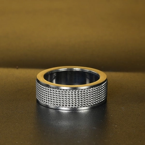 Detail of silver rotatable woven mesh ring with polished inner band and wide metal surface