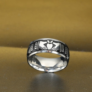 Macro shot of Claddagh crown and hands design on black enamel stainless steel ring