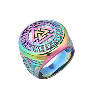 Macro shot of rainbow stainless steel Valknut ring with engraved Runic symbols on band