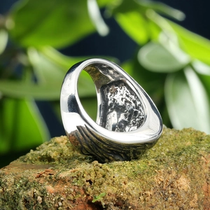 Macro detail of S925 sterling silver stamp and anti-slip texture inside a punk skull ring